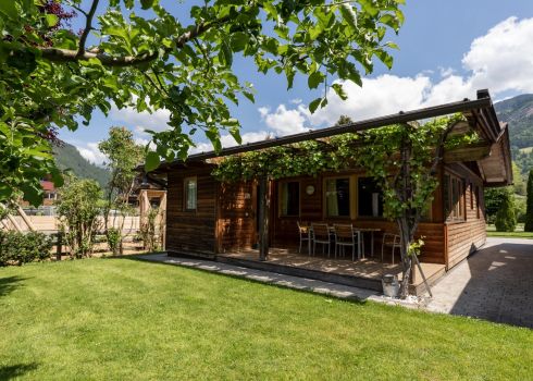 Kleines Chalet aus Holz mit großem Garten